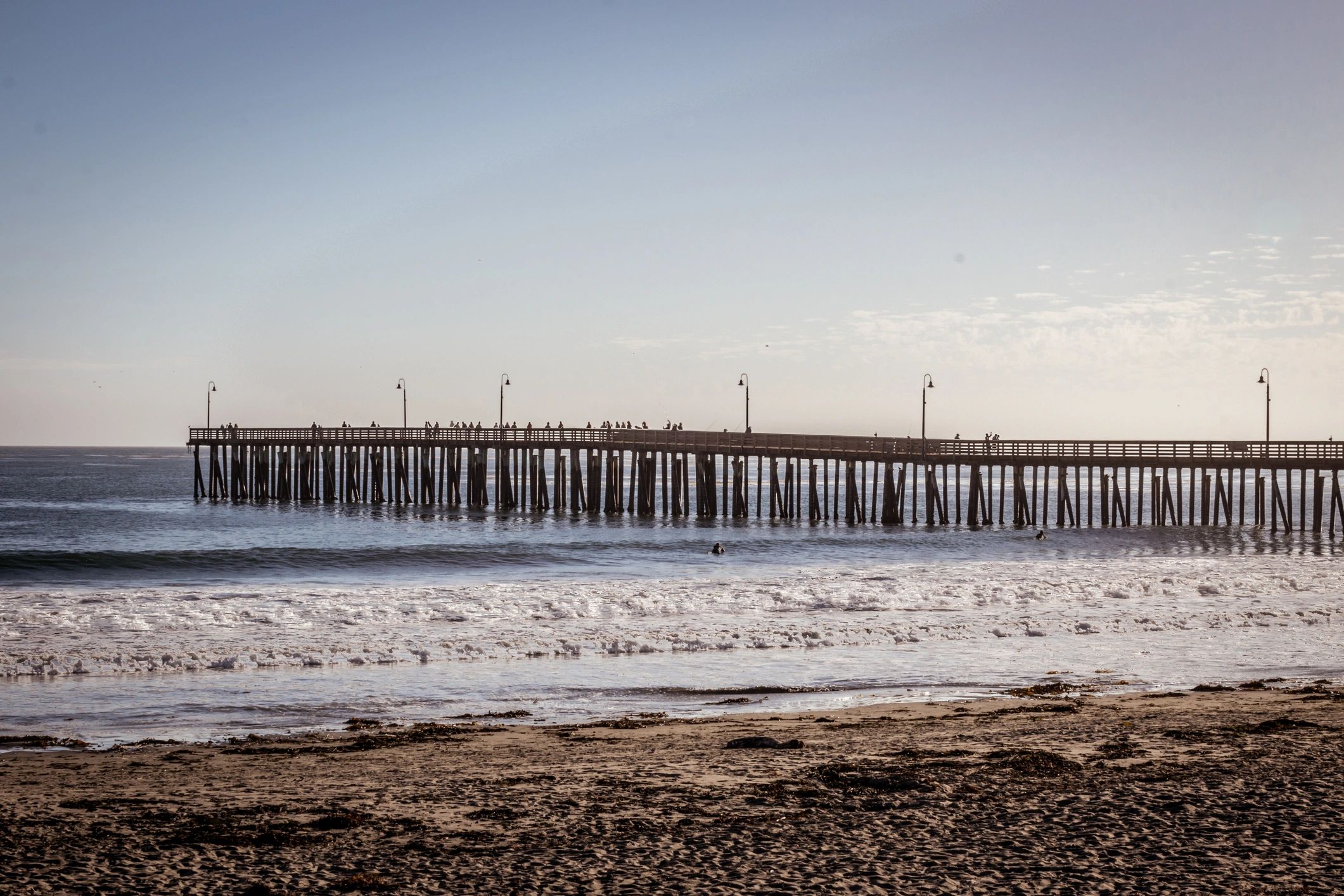 Pier extending into the ocean at sunset