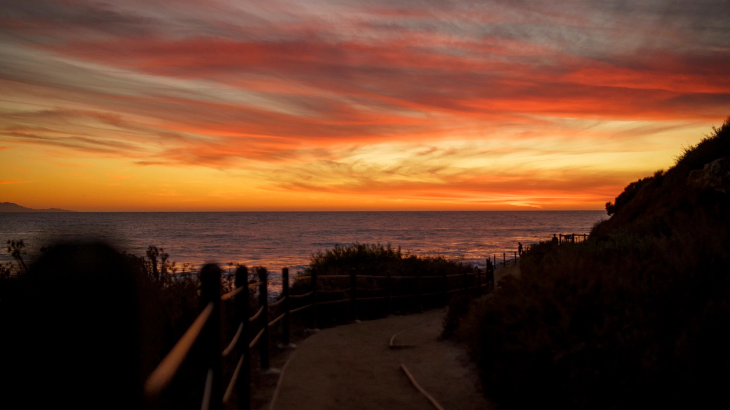Vibrant orange and red sunset over the Pacific coast